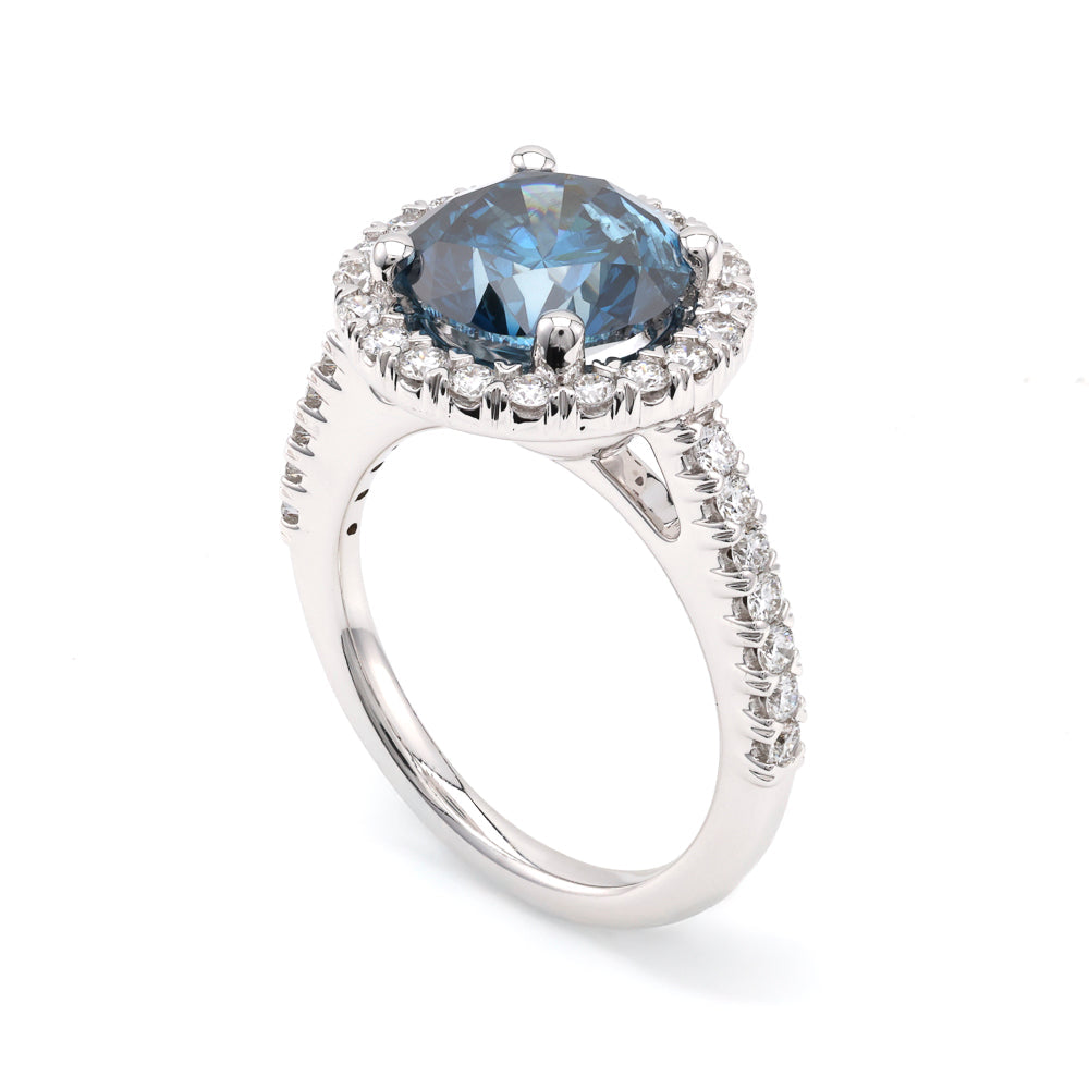 Blue diamond halo engagement ring.