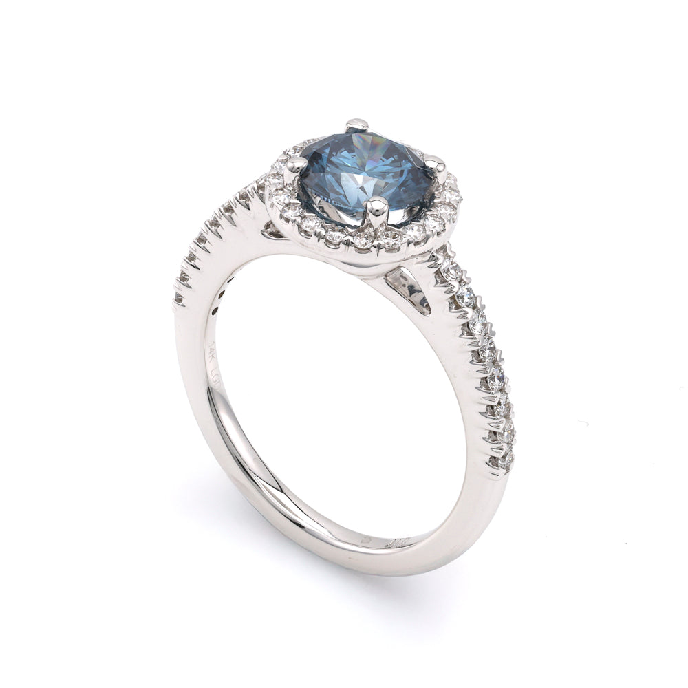 Blue diamond halo engagement ring in white gold.