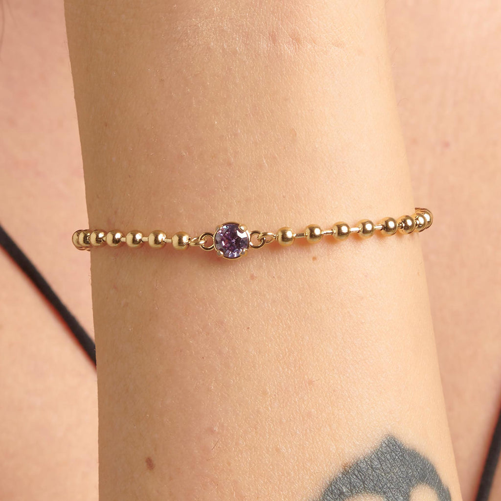 Yellow ball chain bracelet with purple gemstone.