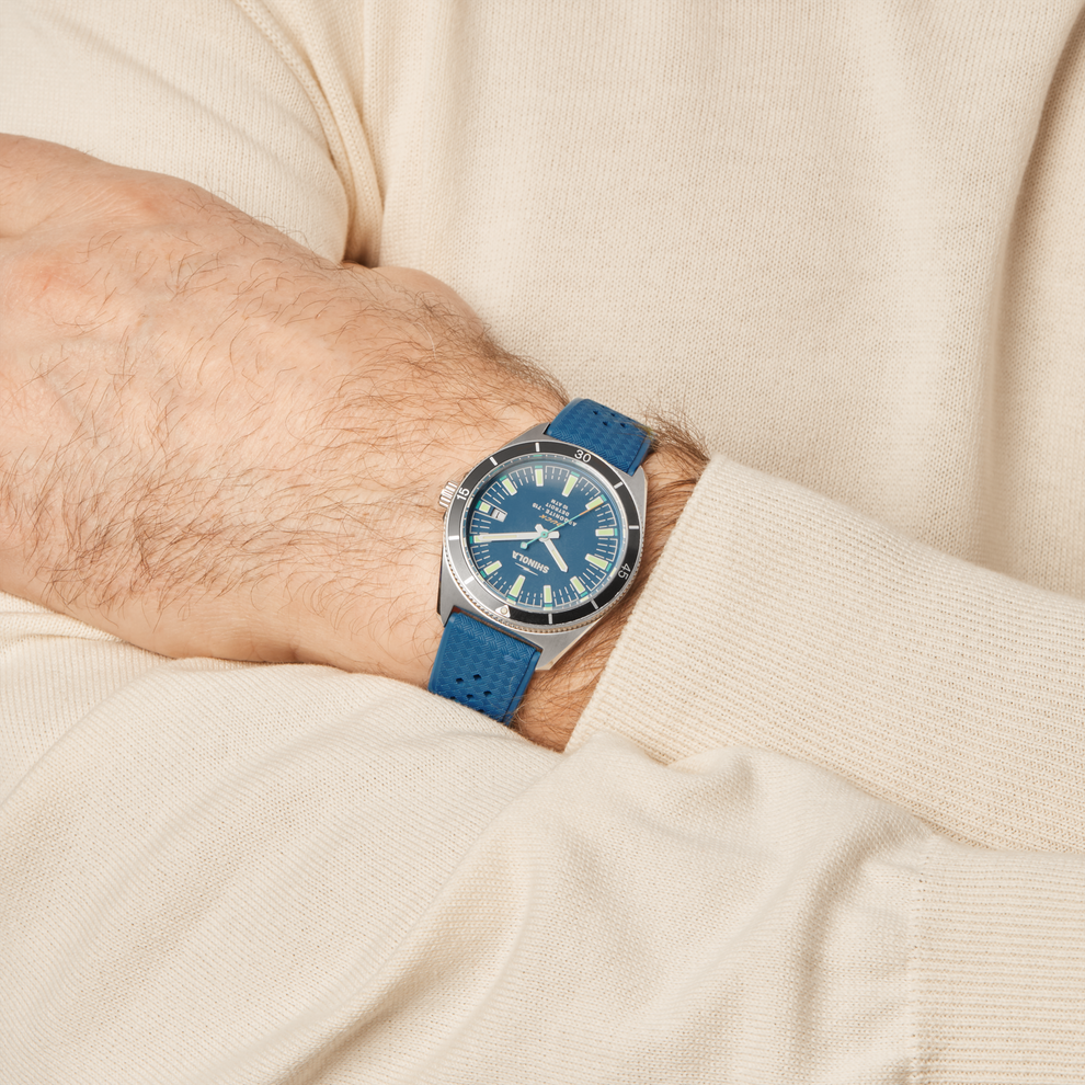 Blue dial watch with blue rubber strap.