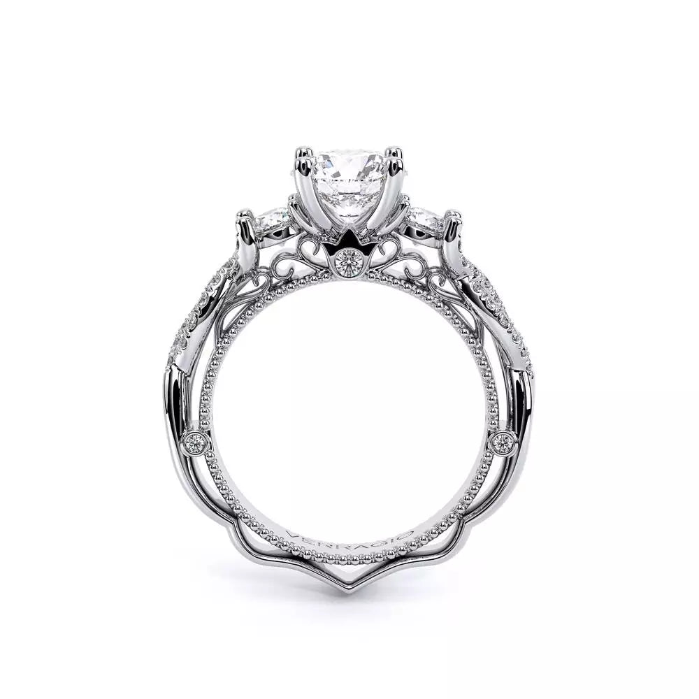 Three-stone diamond ring with intricate detailing.