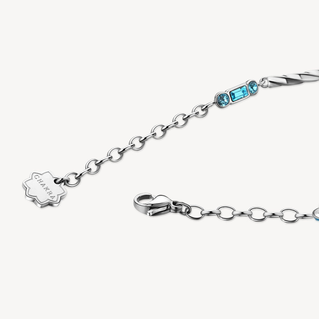 Stainless steel bracelet with blue gemstones.