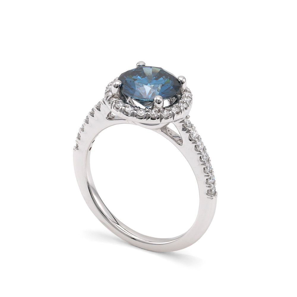 Blue diamond halo engagement ring in white gold.