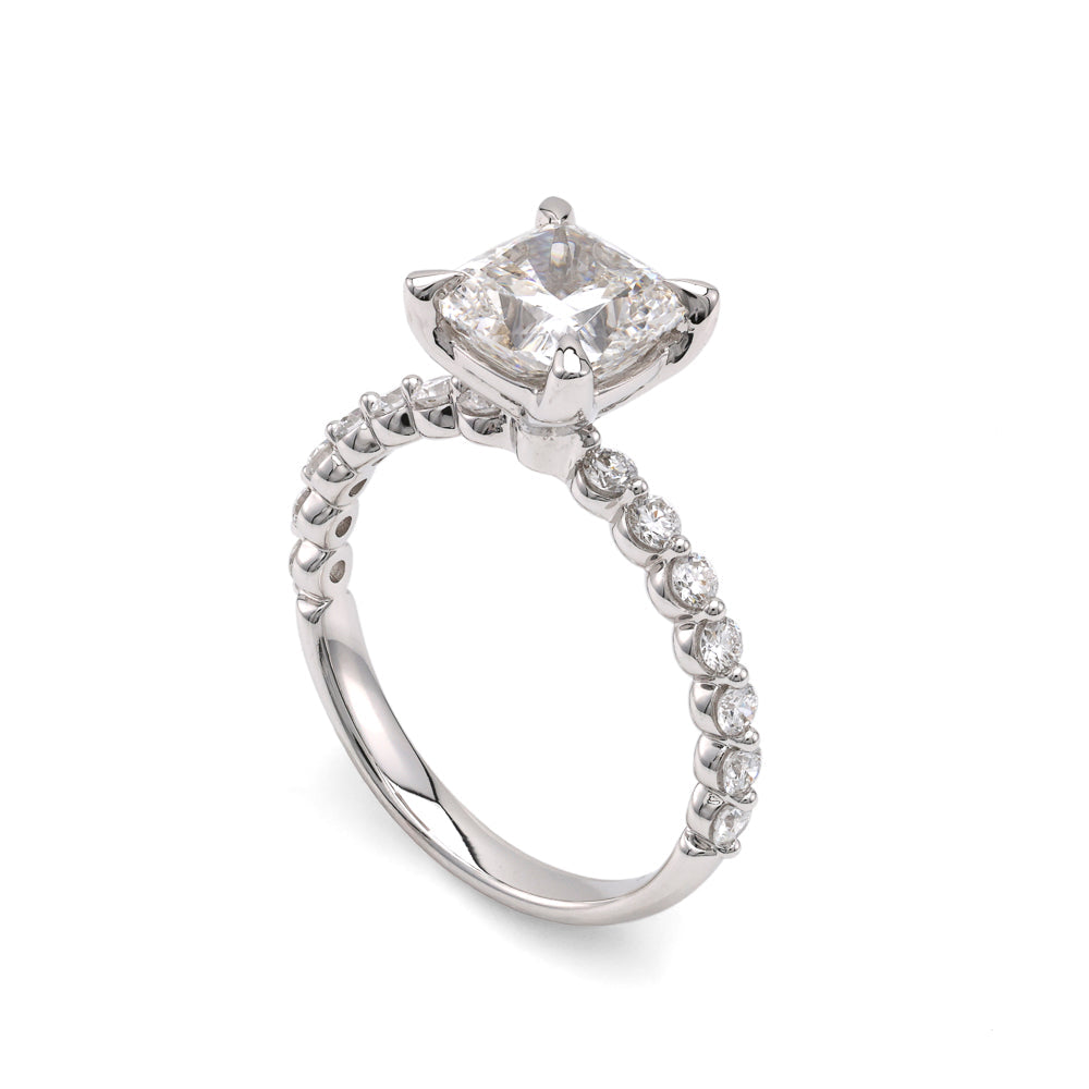 Cushion diamond ring with round accents.