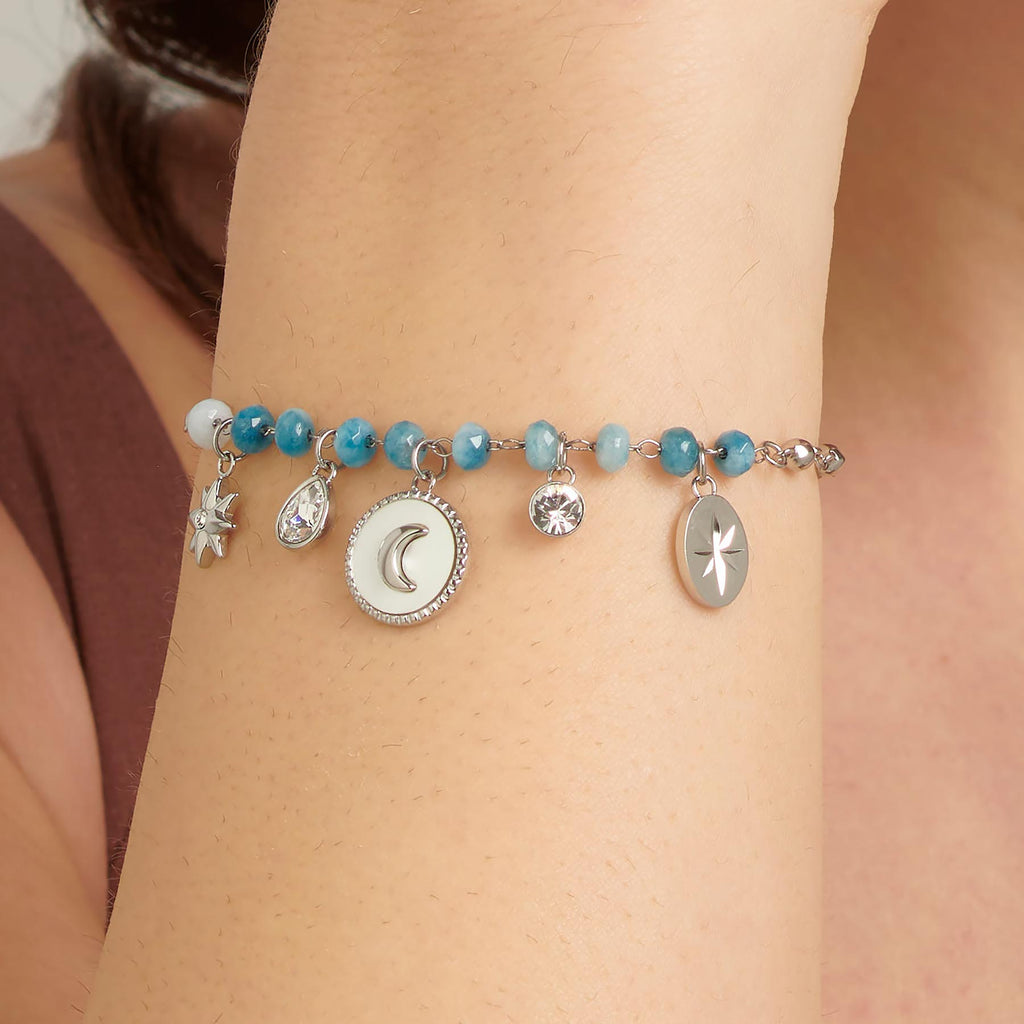 Blue gemstone bracelet with silver charms.