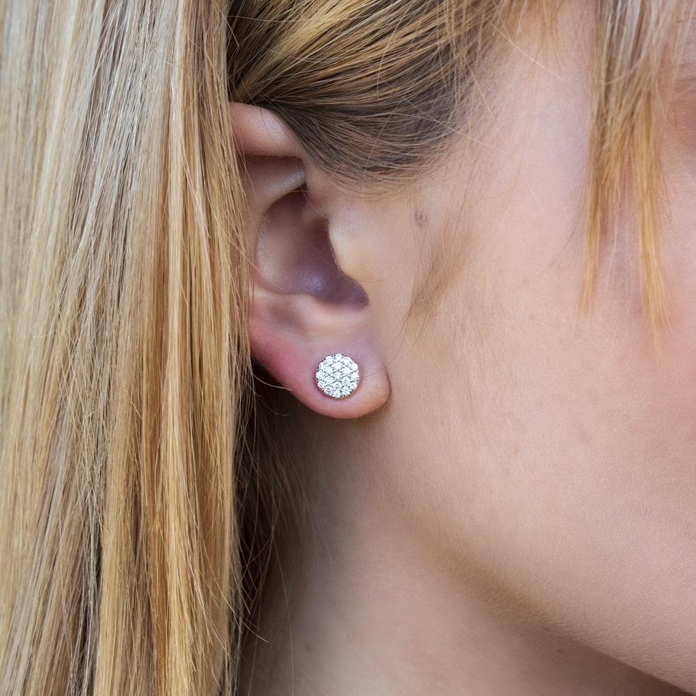 Round diamond cluster earrings in white gold.