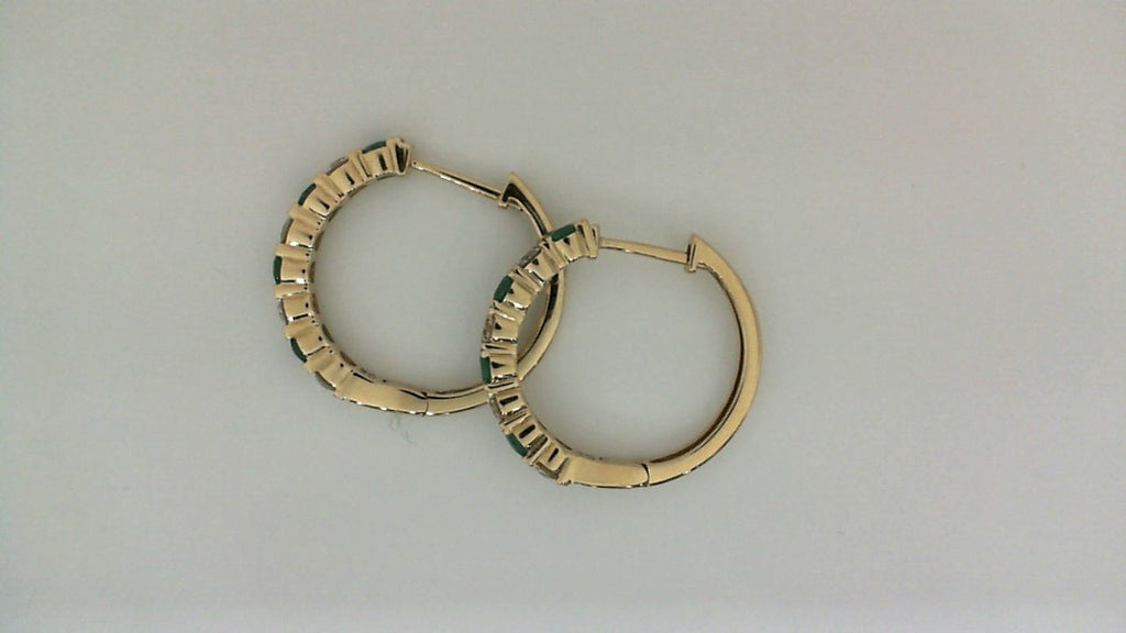 Yellow gold hoop earrings with emerald accents.