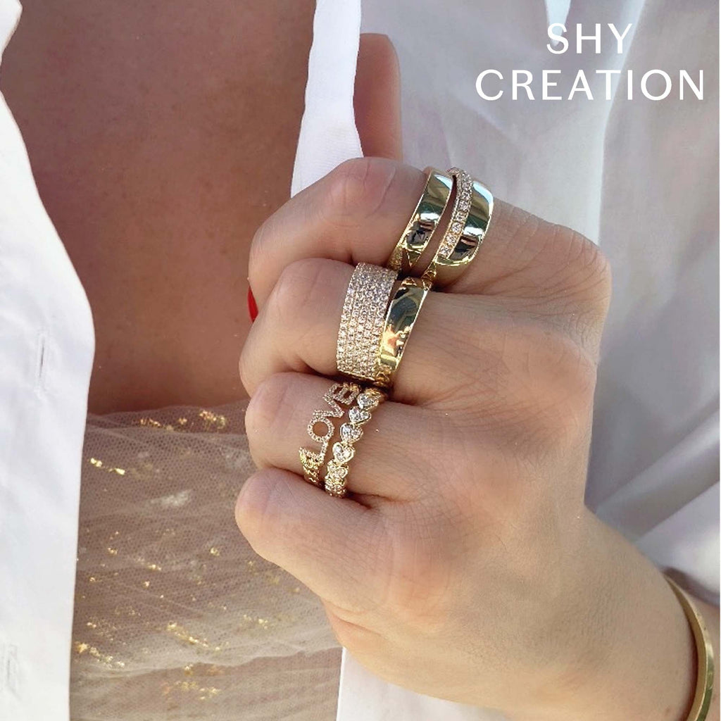 Yellow gold diamond rings on hand.