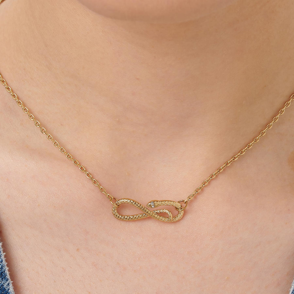 Gold infinity necklace with simulated diamonds.
