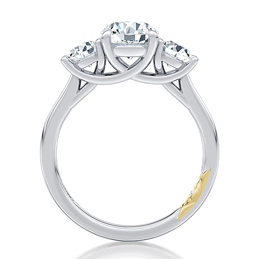 Three-stone diamond ring, intricate white gold design.