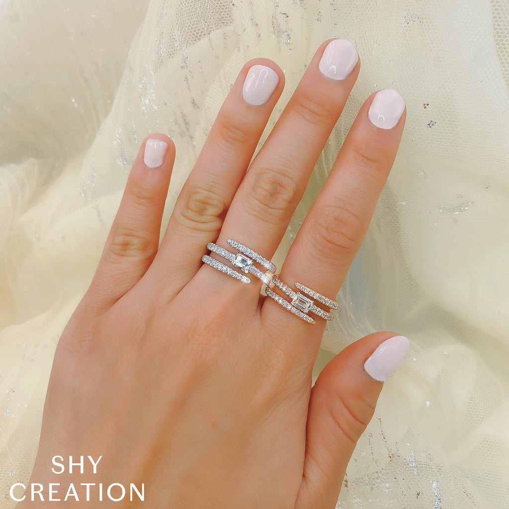 White gold diamond ring with multiple bands.