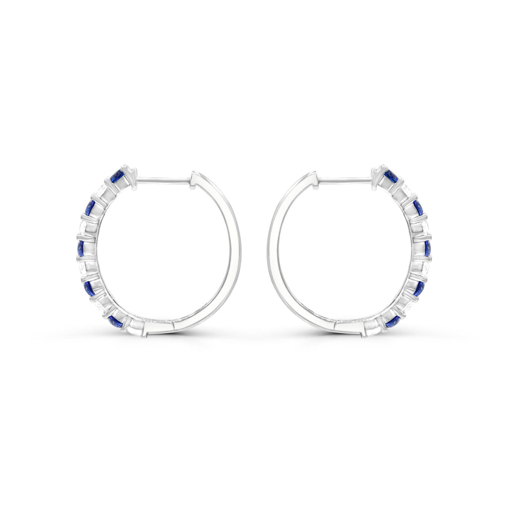 Sterling silver hoops with blue sapphires.