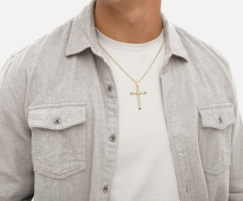 Yellow gold cross necklace on diamond-cut chain.