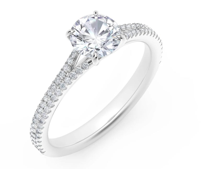 Platinum ring with round diamond and side stones.