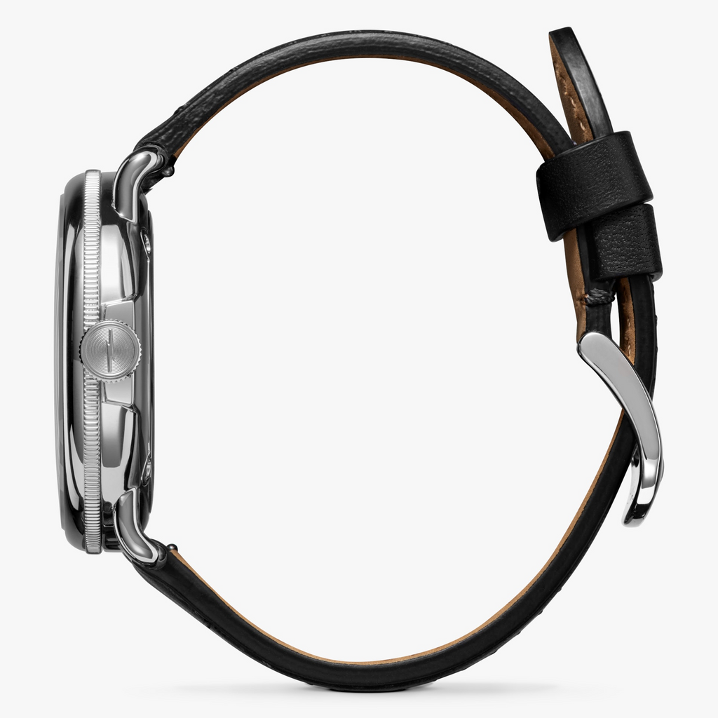 Stainless steel watch, black leather strap.