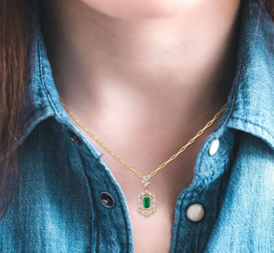 Emerald pendant with diamond accents.