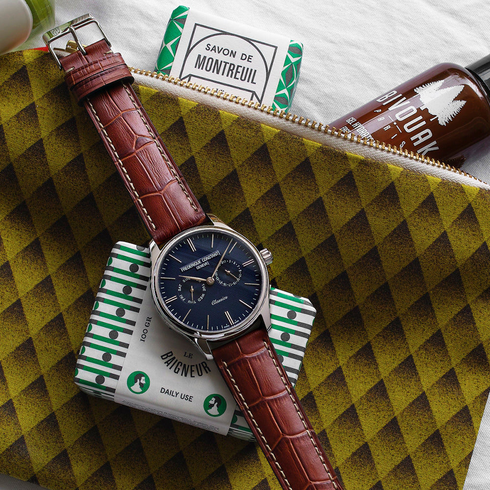 Brown leather strap, blue dial, stainless steel watch.