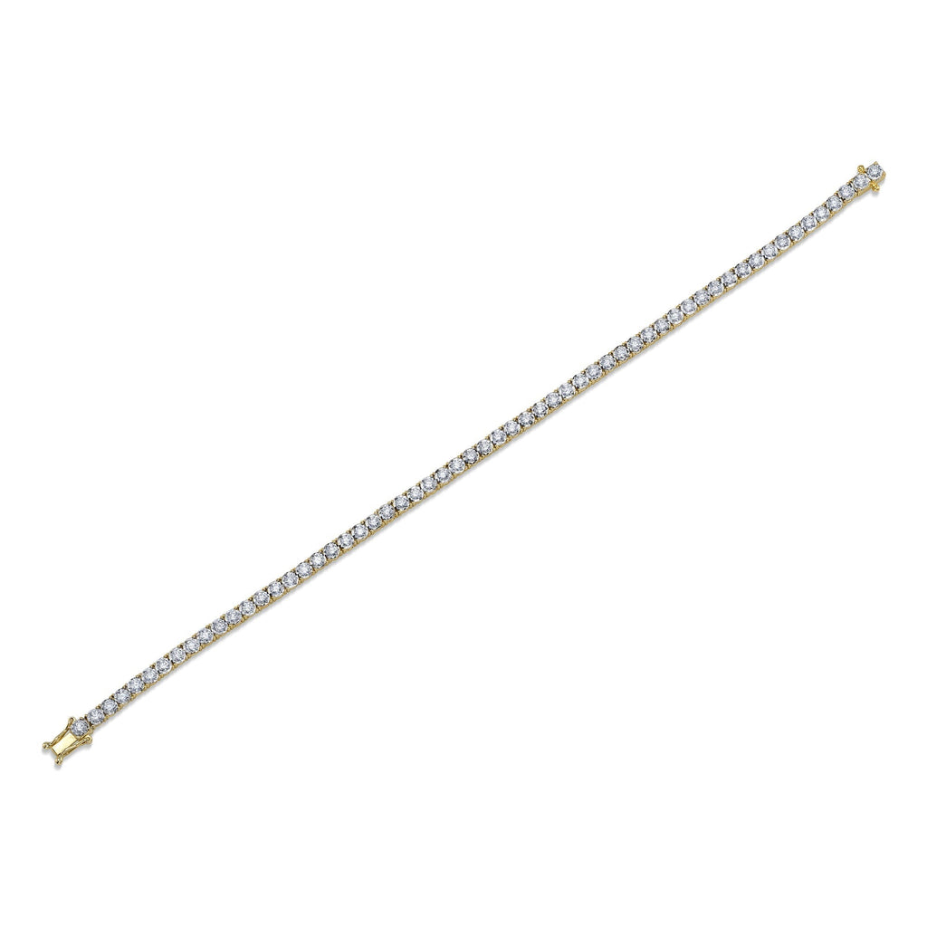 Yellow gold tennis bracelet with diamonds.