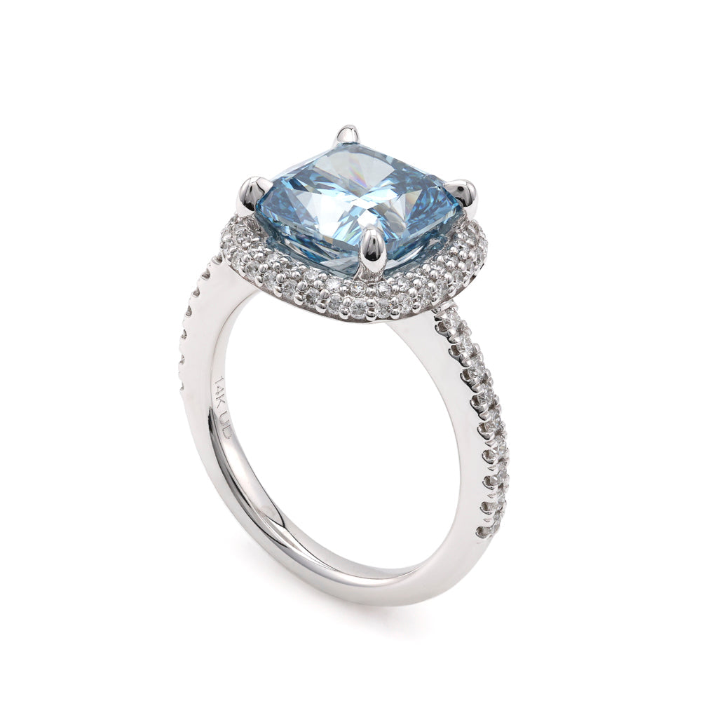 Blue diamond halo engagement ring in white gold.
