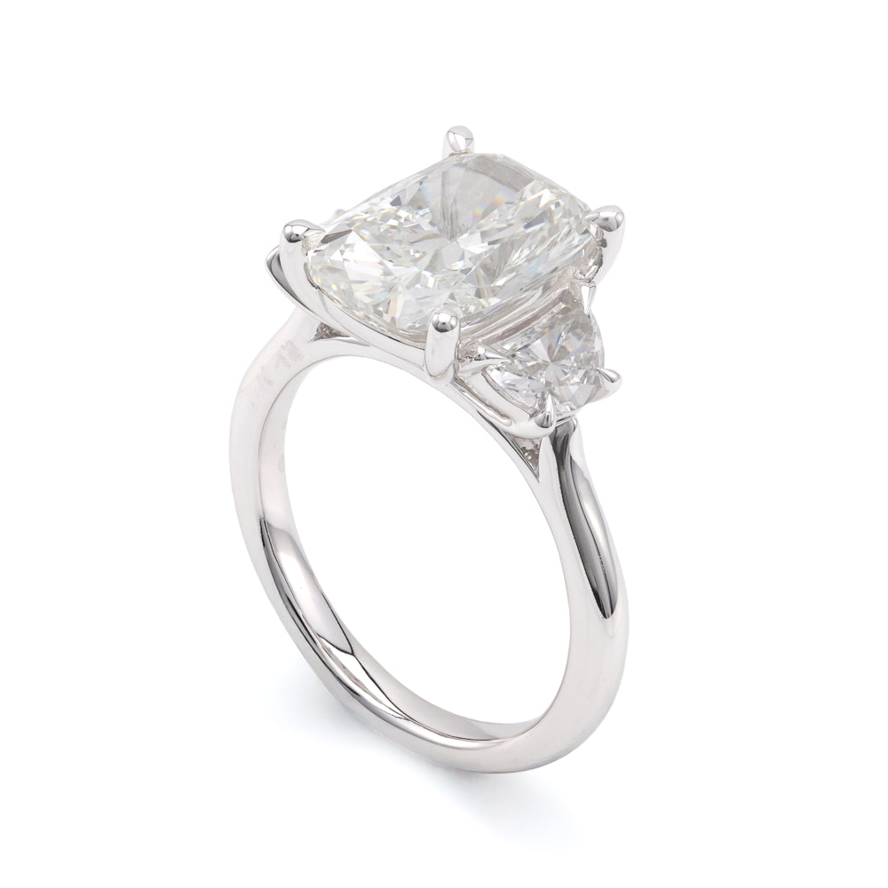 Three-stone white gold diamond engagement ring.