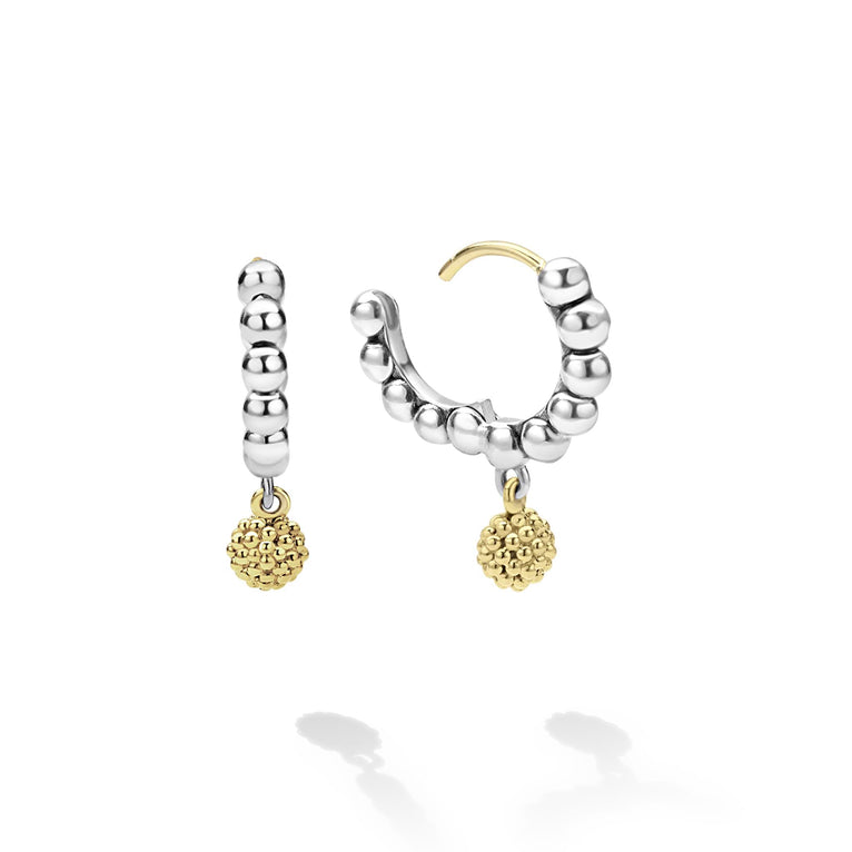 Sterling silver huggie earrings with gold accents.