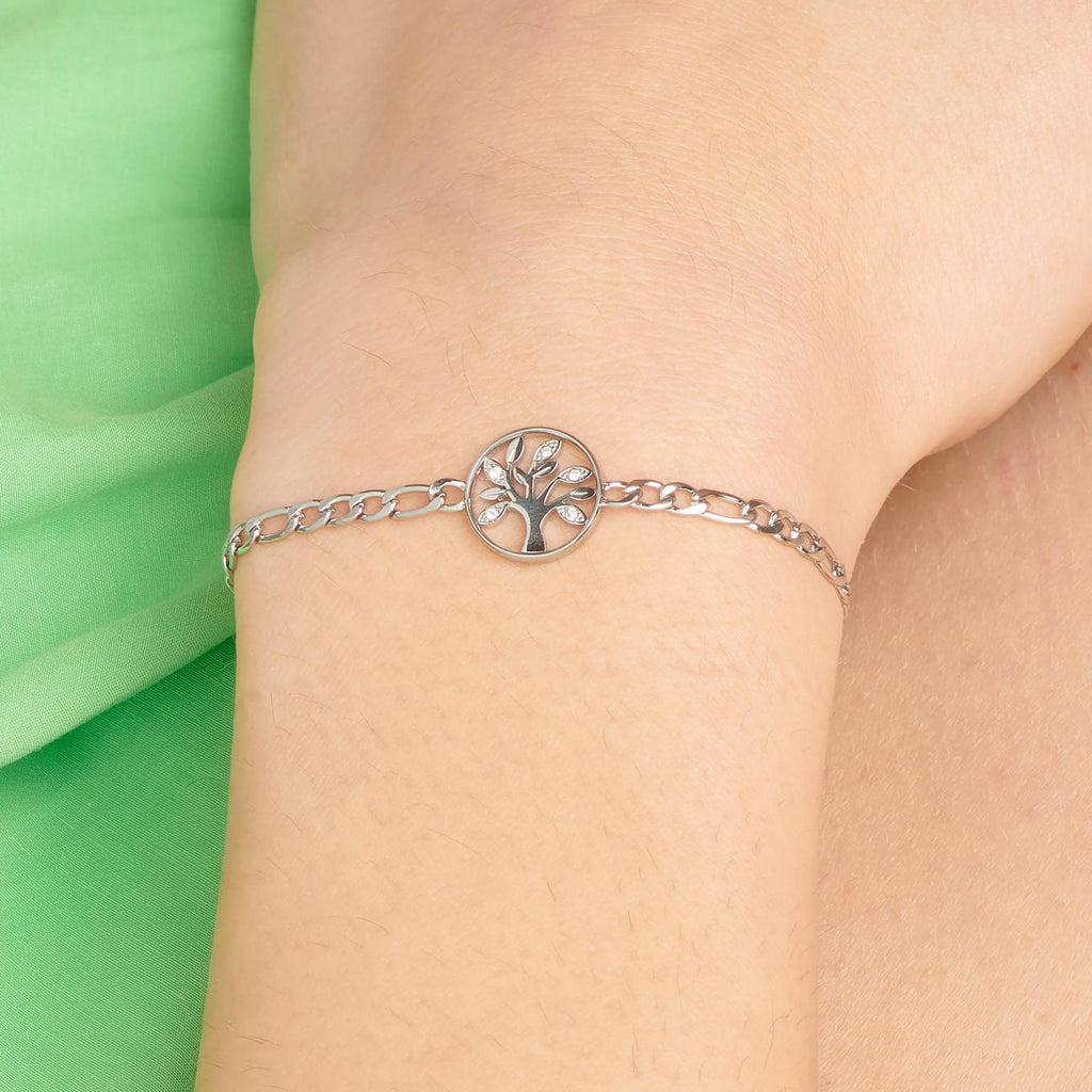 Tree charm bracelet on wrist.