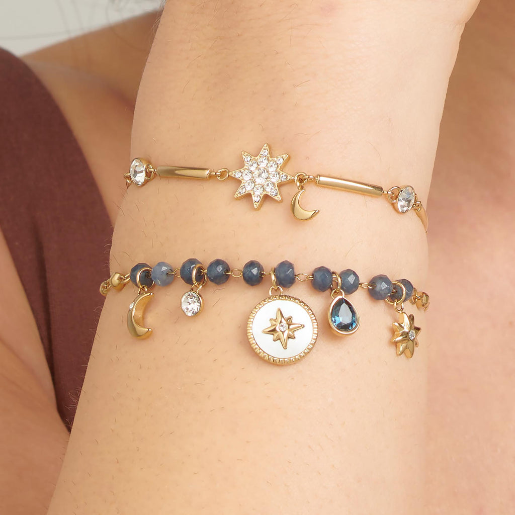 Yellow bracelet with star and moon charms.