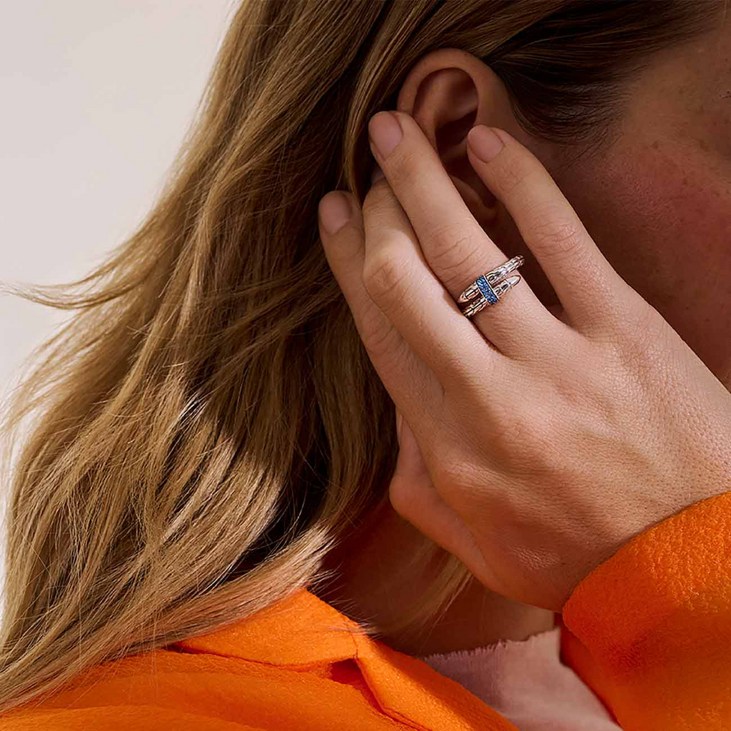 Sterling silver ring with blue sapphire accent.