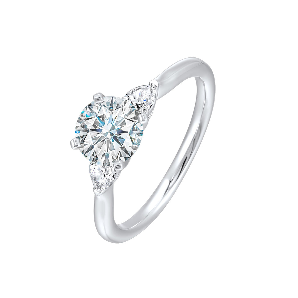 Three-stone diamond ring with pear accents.
