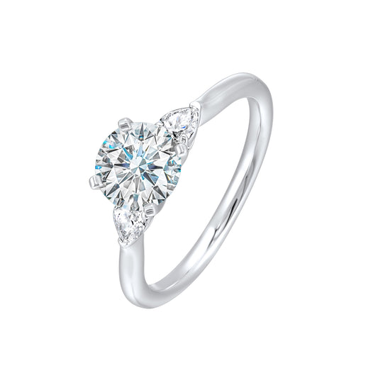 Three-stone diamond ring with pear accents.