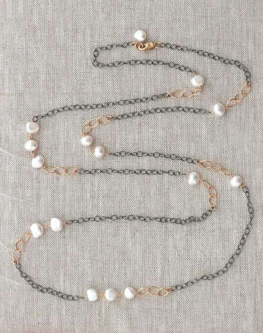 Gold-filled necklace with white pearls.