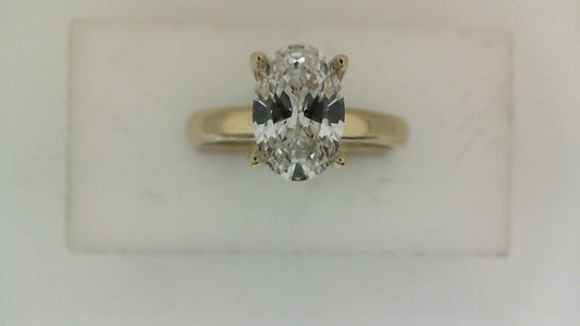 Yellow gold ring with oval diamond centerpiece.