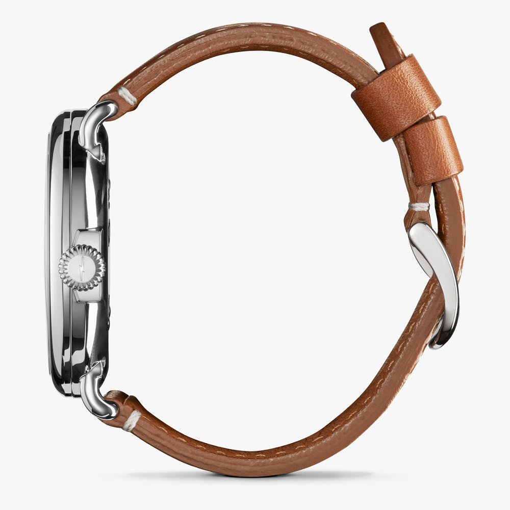 Silver watch with brown leather strap.