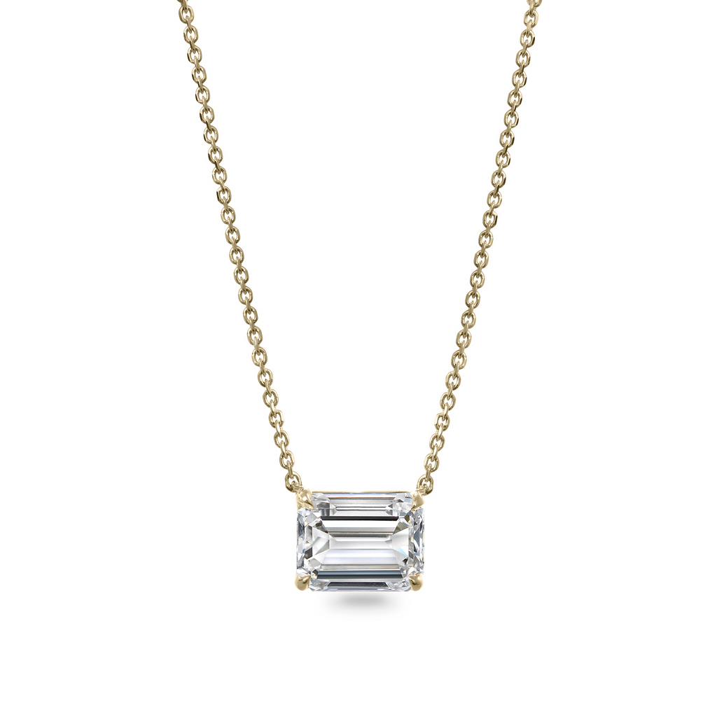 Emerald-cut diamond pendant on gold chain.
