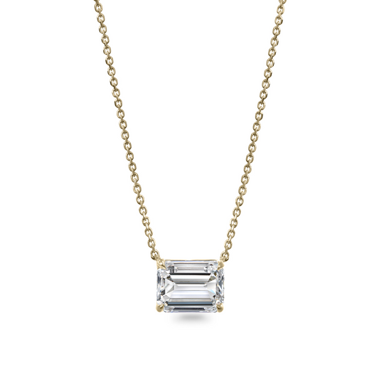 Emerald-cut diamond pendant on gold chain.