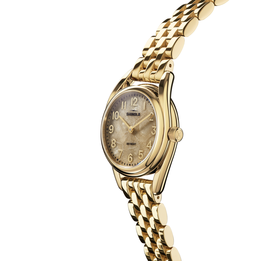 Gold-tone watch with tan dial, stainless steel.