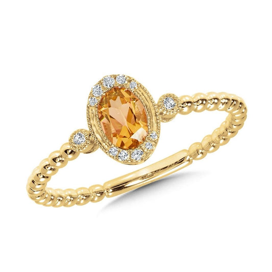 Oval citrine ring with diamond accents.