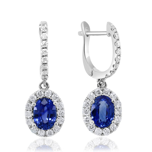 Oval sapphire earrings with diamond halo.