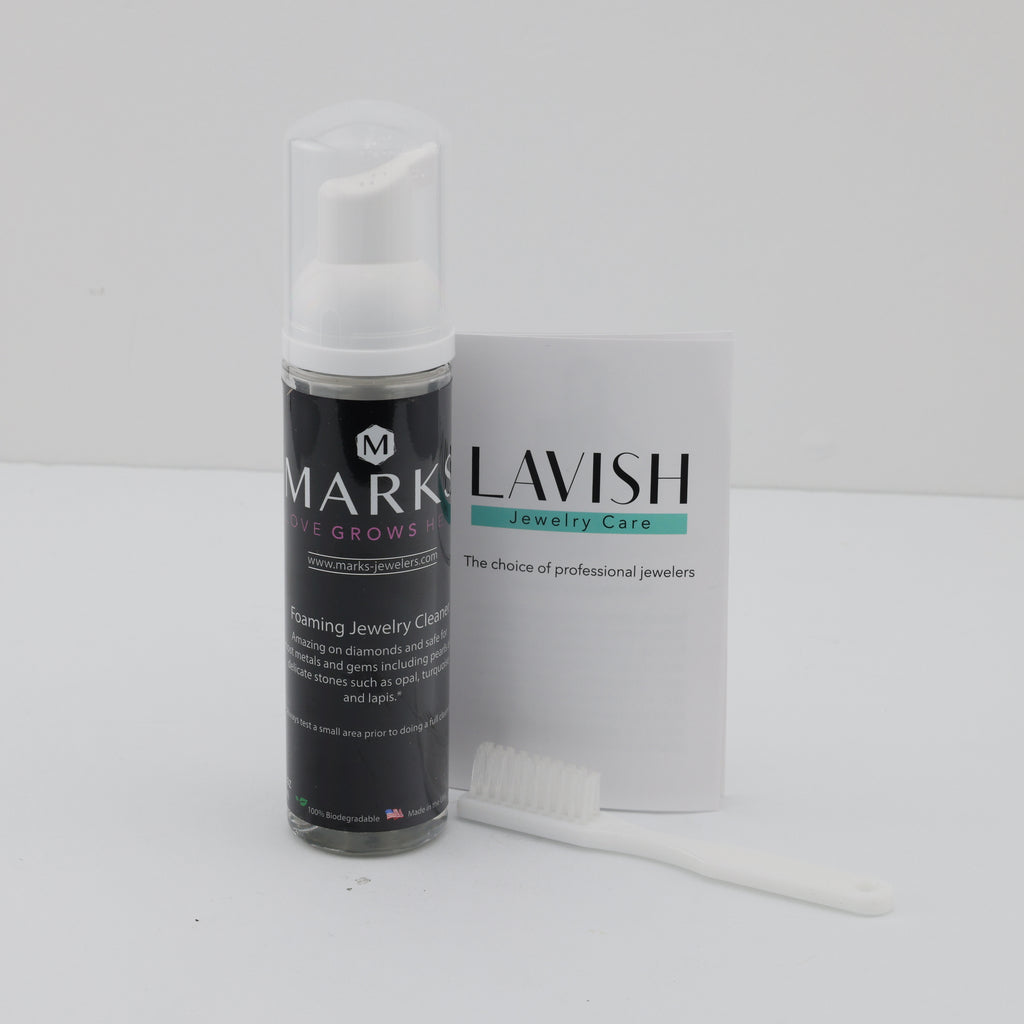 Foaming jewelry cleaner with brush and booklet.