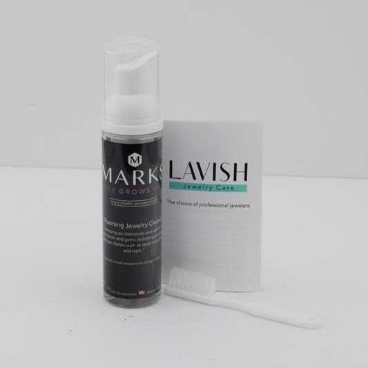 Foaming jewelry cleaner with brush and booklet.