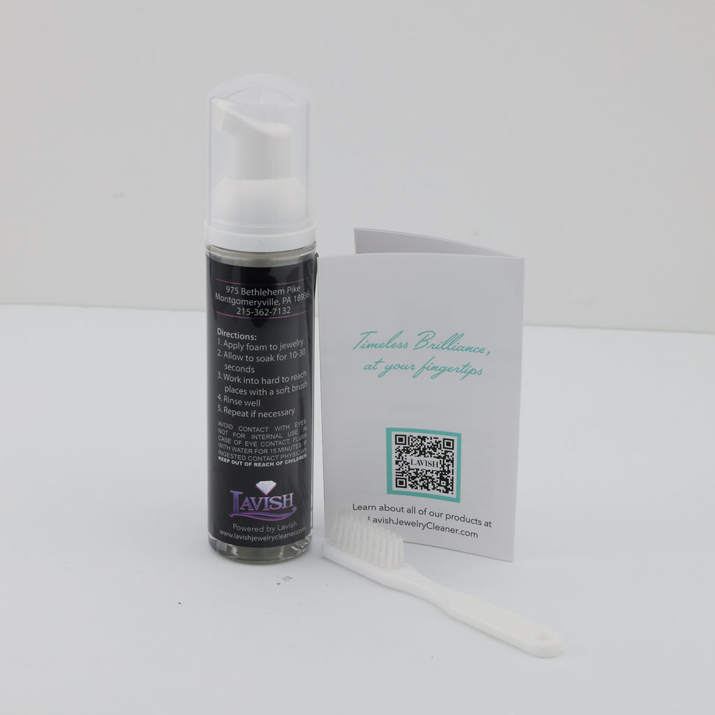 Foaming jewelry cleaner with brush and instructions.