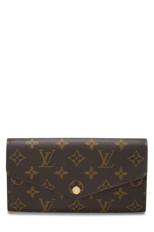 Brown leather wallet with gold monogram pattern.