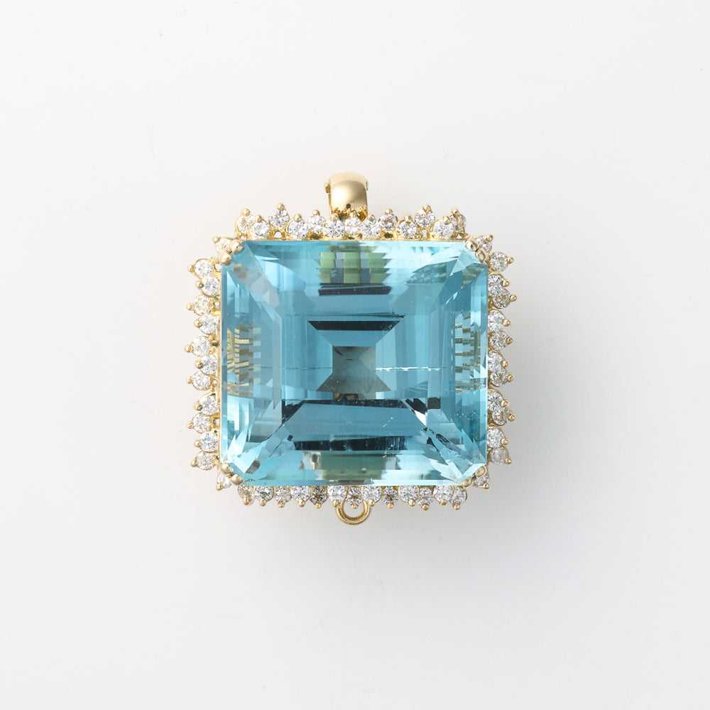 Cushion blue topaz, diamond halo, yellow gold.