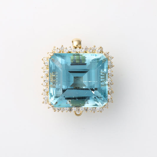 Cushion blue topaz, diamond halo, yellow gold.