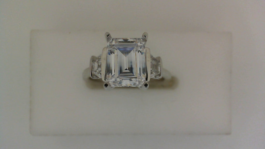 White gold ring with three trapezoid diamonds.