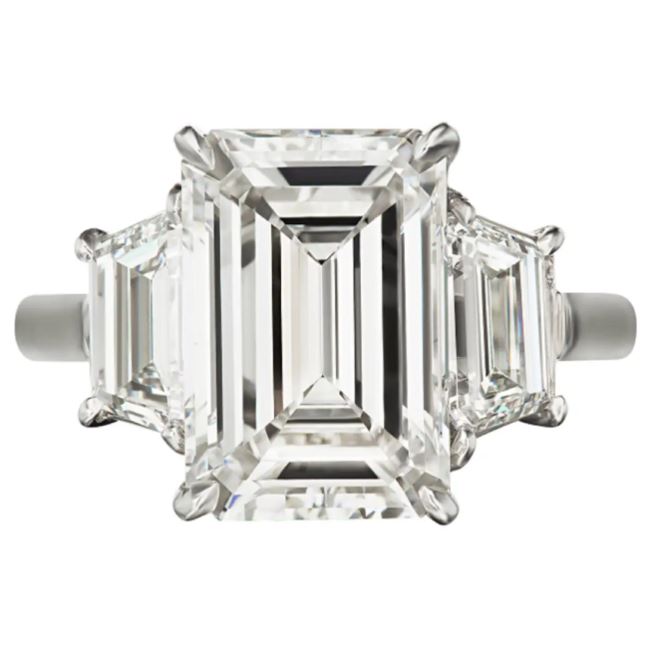 Emerald-cut diamond ring with trapezoid accents.
