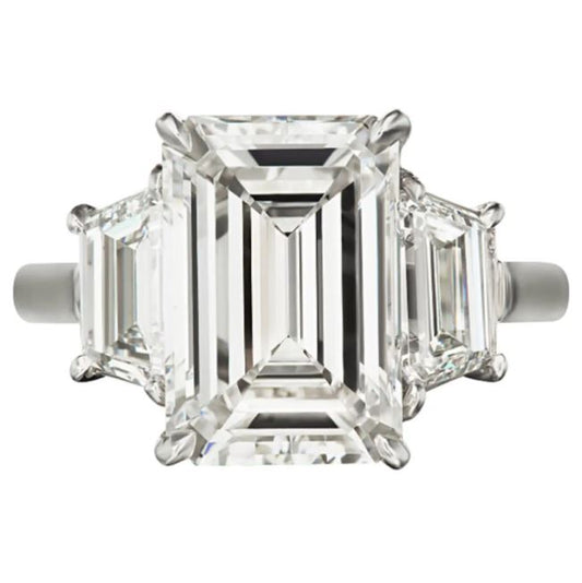 Emerald-cut diamond ring with trapezoid accents.