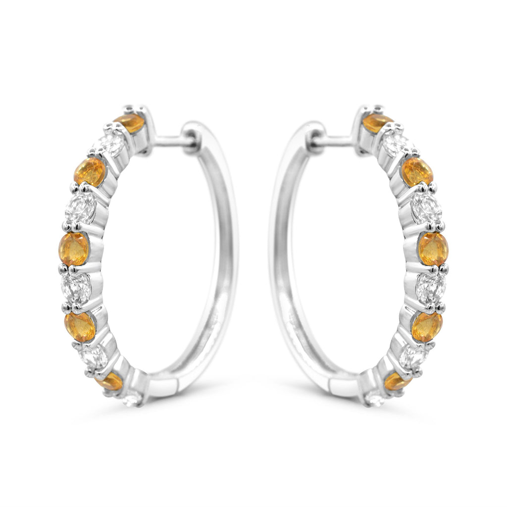 Sterling silver hoops with citrines and sapphires.