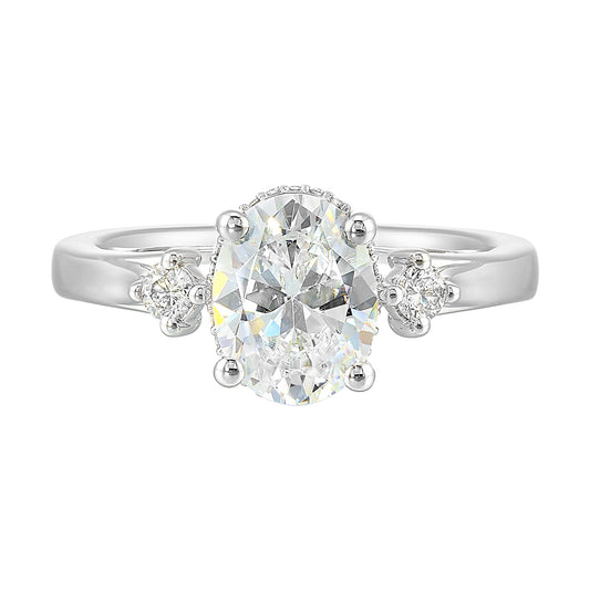 Oval diamond ring with side stones.