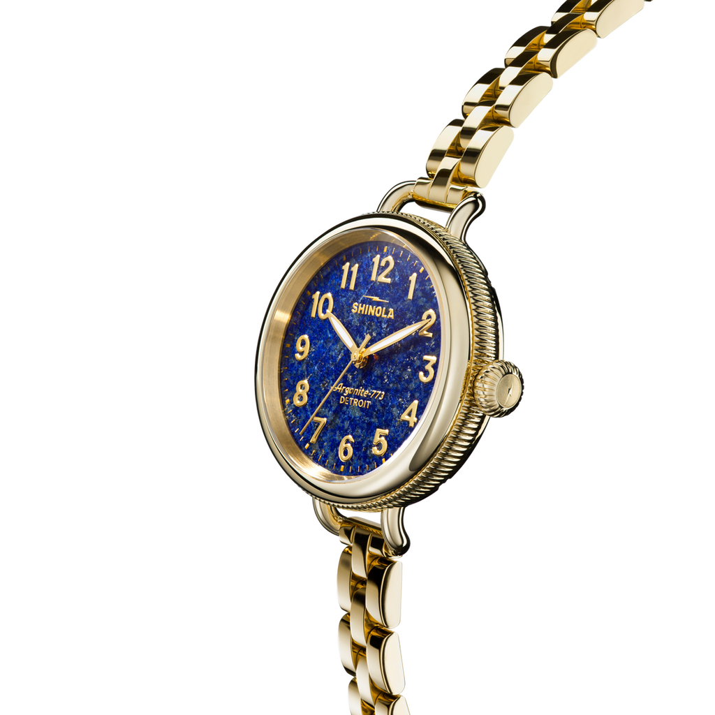 Gold-tone watch with blue dial, stainless steel.